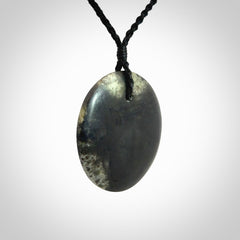 A Hand Carved New Zealand jade disc pendant