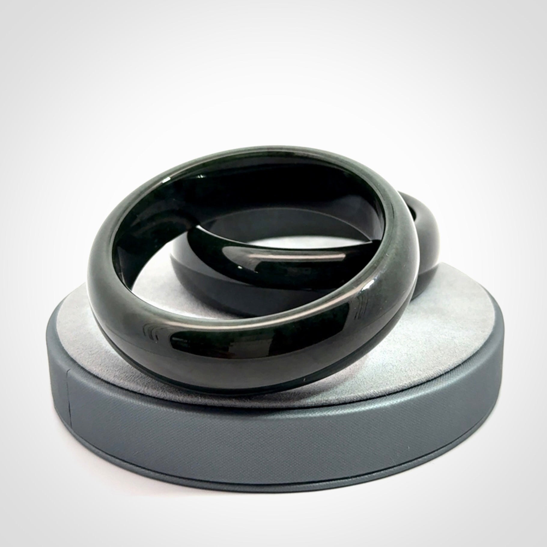 Hand carved black jade bangle. Carved from black jade. This is a solid jade bangle carved from a single piece of jade. It is polished to a soft shine. The jade is otherwise untreated and completely natural.