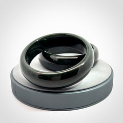 Hand carved black jade bangle. Carved from black jade. This is a solid jade bangle carved from a single piece of jade. It is polished to a soft shine. The jade is otherwise untreated and completely natural.