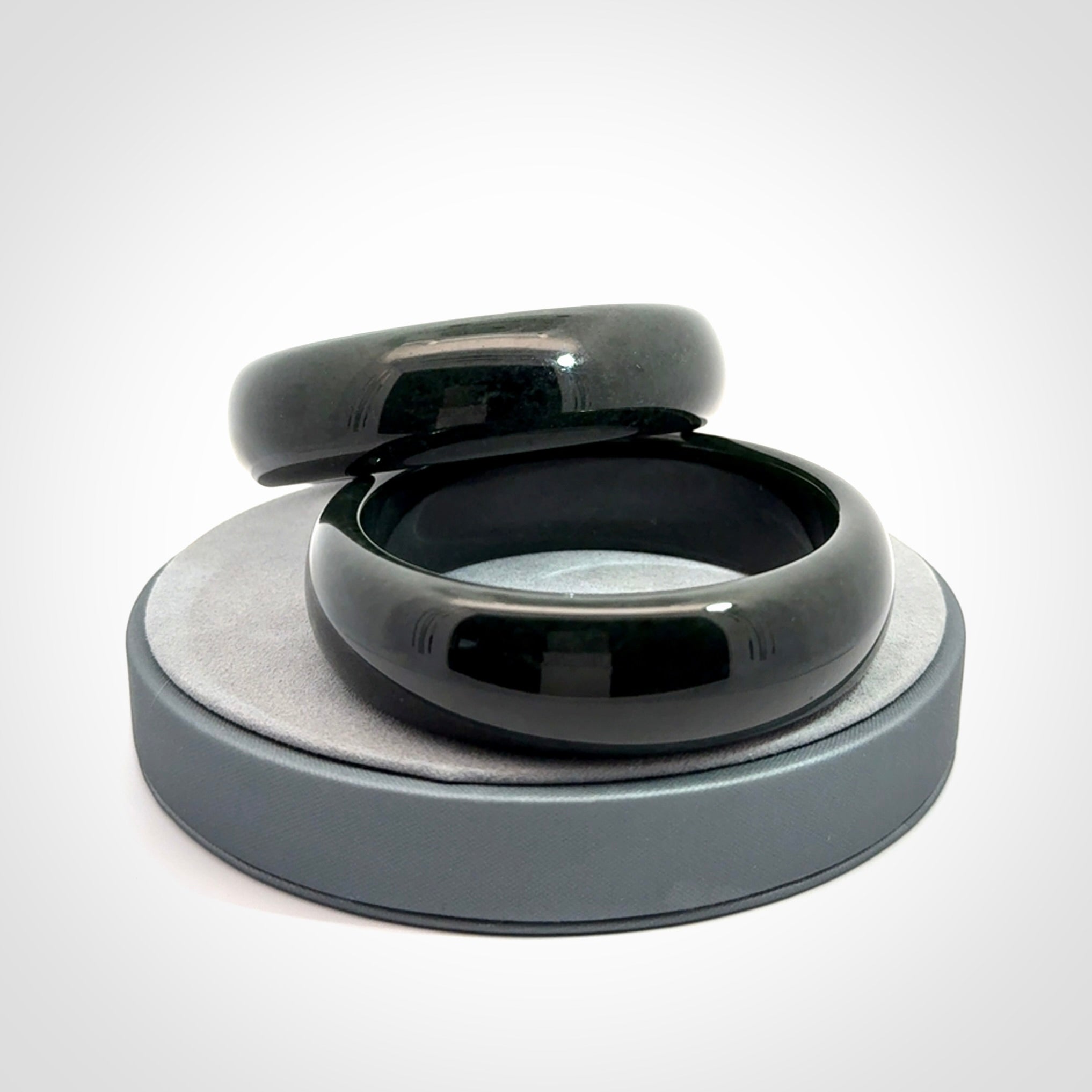 Hand carved black jade bangle. Carved from black jade. This is a solid jade bangle carved from a single piece of jade. It is polished to a soft shine. The jade is otherwise untreated and completely natural.