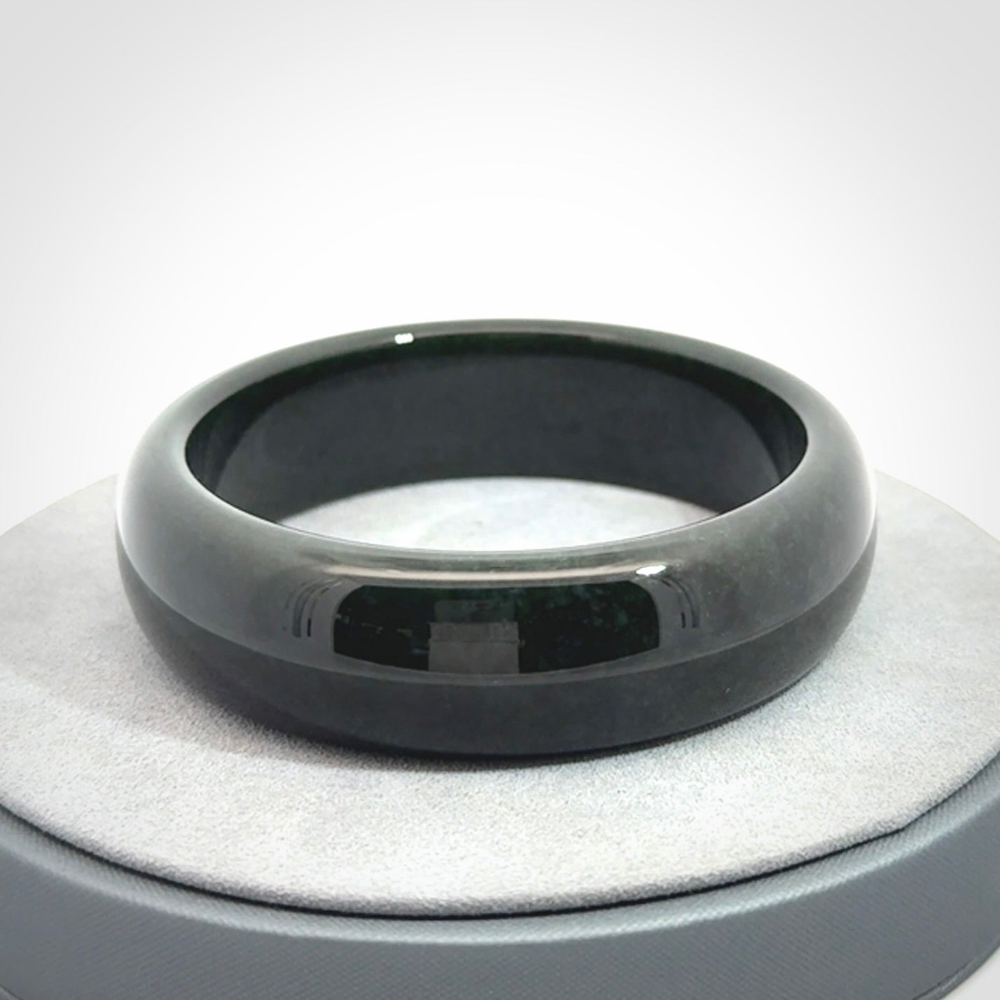 Hand carved black jade bangle. Carved from black jade. This is a solid jade bangle carved from a single piece of jade. It is polished to a soft shine. The jade is otherwise untreated and completely natural.