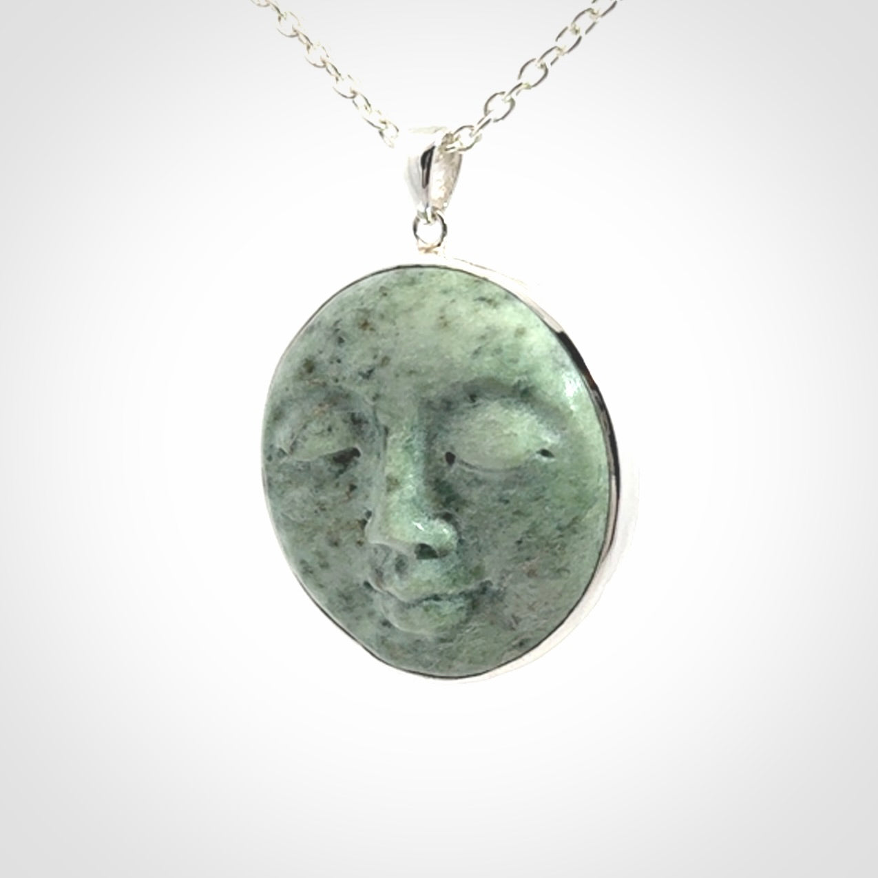 Hand made New Zealand Jade moon face necklace with Sterling Silver. Made by NZ Pacific and sale online only. Delivered with sterling silver chain and packaged in a woven kete pouch.