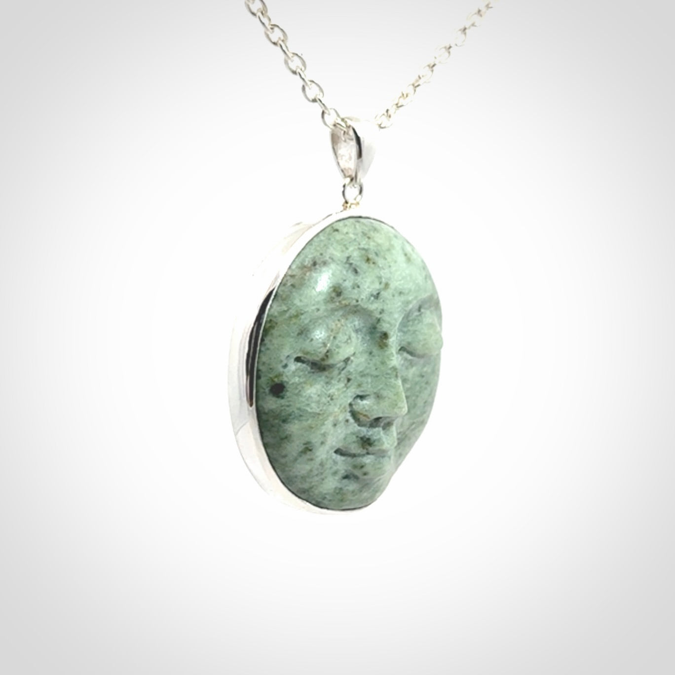 Hand made New Zealand Jade moon face necklace with Sterling Silver. Made by NZ Pacific and sale online only. Delivered with sterling silver chain and packaged in a woven kete pouch.