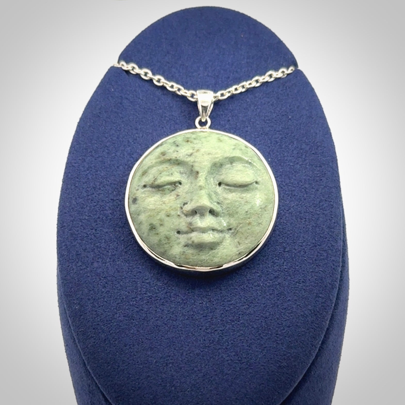Hand made New Zealand Jade moon face necklace with Sterling Silver. Made by NZ Pacific and sale online only. Delivered with sterling silver chain and packaged in a woven kete pouch.