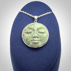 Hand made New Zealand Jade moon face necklace with Sterling Silver. Made by NZ Pacific and sale online only. Delivered with sterling silver chain and packaged in a woven kete pouch.