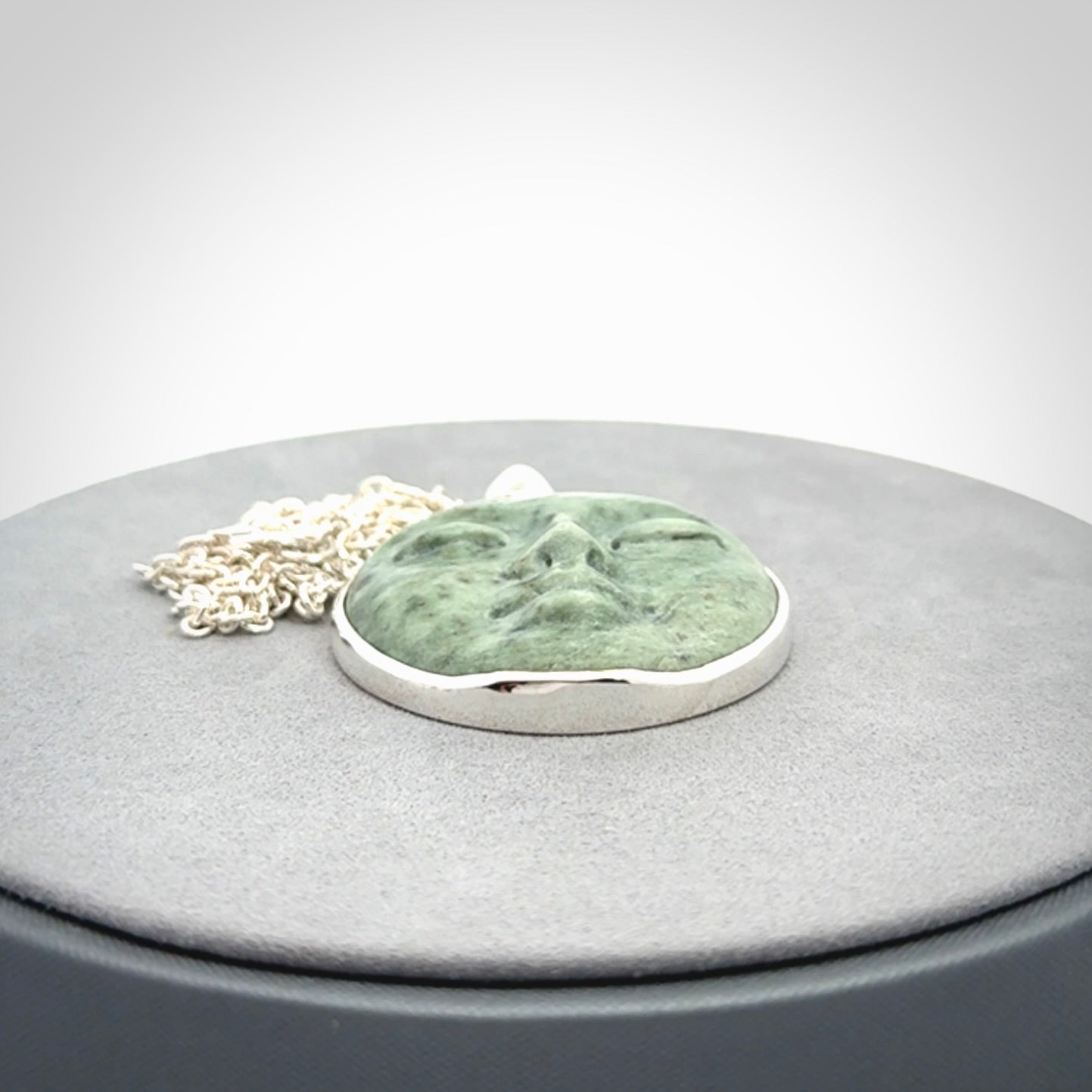 Hand made New Zealand Jade moon face necklace with Sterling Silver. Made by NZ Pacific and sale online only. Delivered with sterling silver chain and packaged in a woven kete pouch.