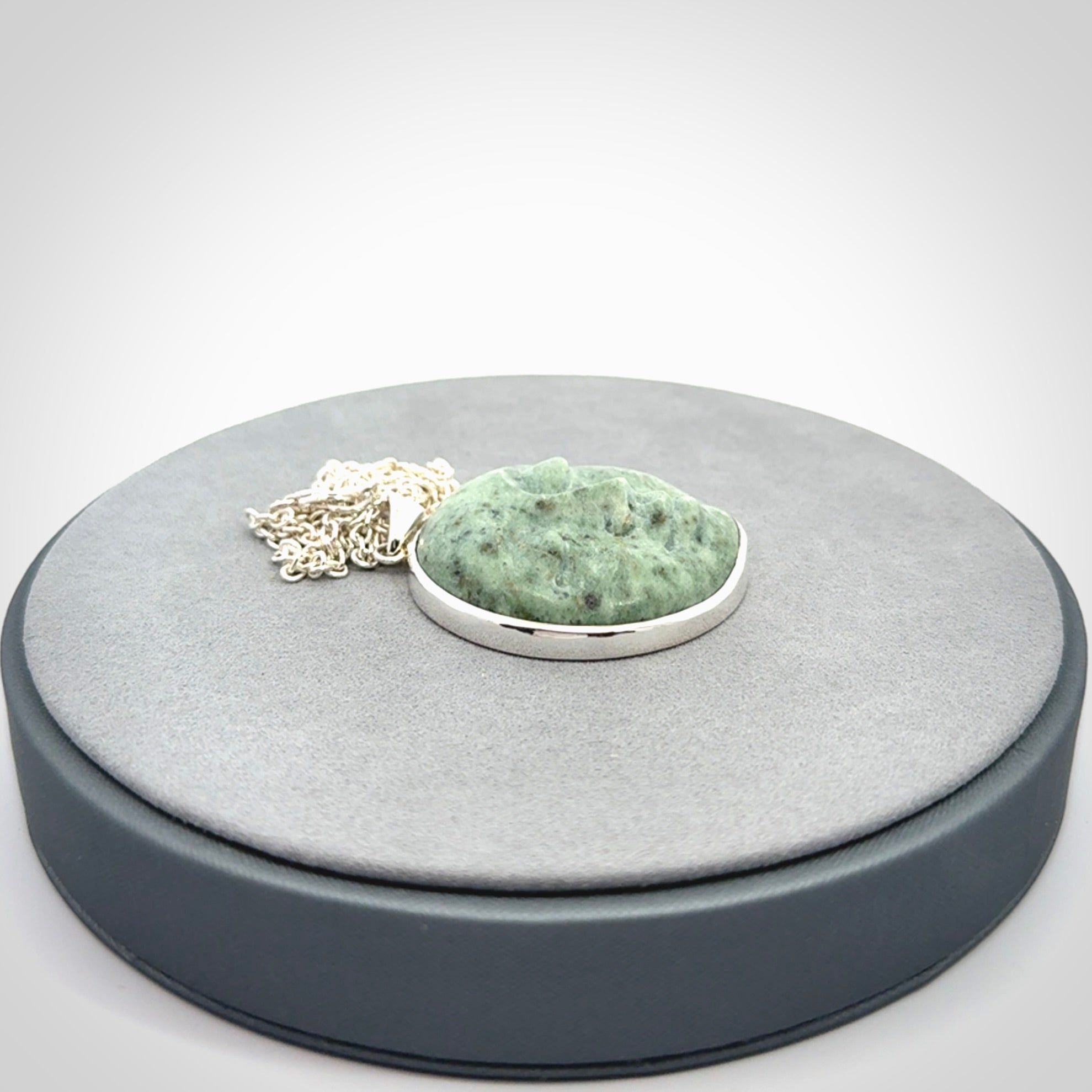 Hand made New Zealand Jade moon face necklace with Sterling Silver. Made by NZ Pacific and sale online only. Delivered with sterling silver chain and packaged in a woven kete pouch.