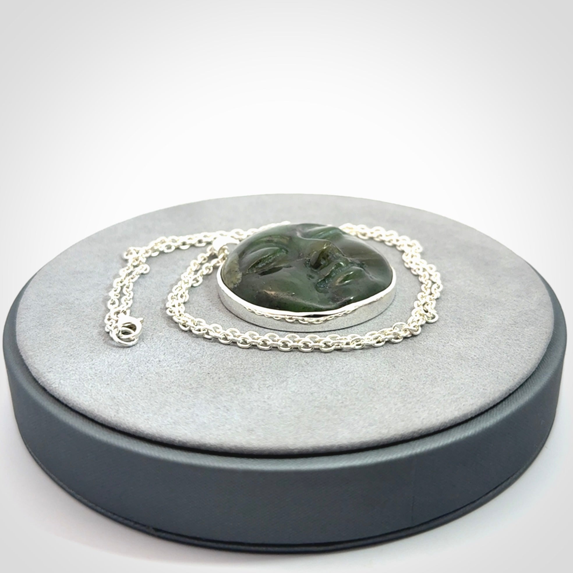 Hand made New Zealand Jade moon face necklace with Sterling Silver. Made by NZ Pacific and sale online only. Delivered with sterling silver chain and packaged in a woven kete pouch.