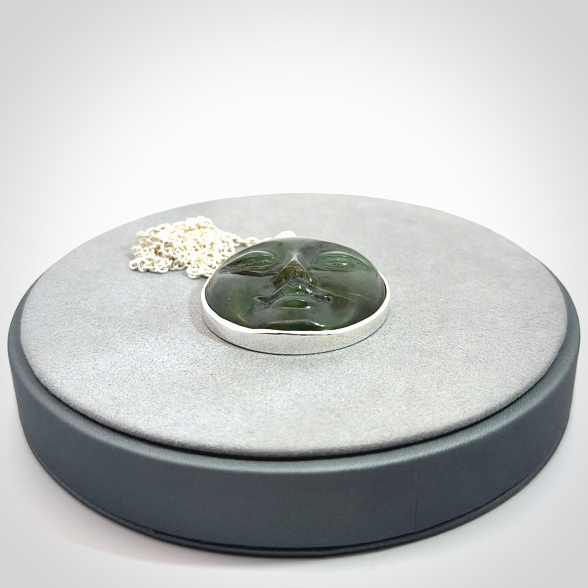 Hand made New Zealand Jade moon face necklace with Sterling Silver. Made by NZ Pacific and sale online only. Delivered with sterling silver chain and packaged in a woven kete pouch.