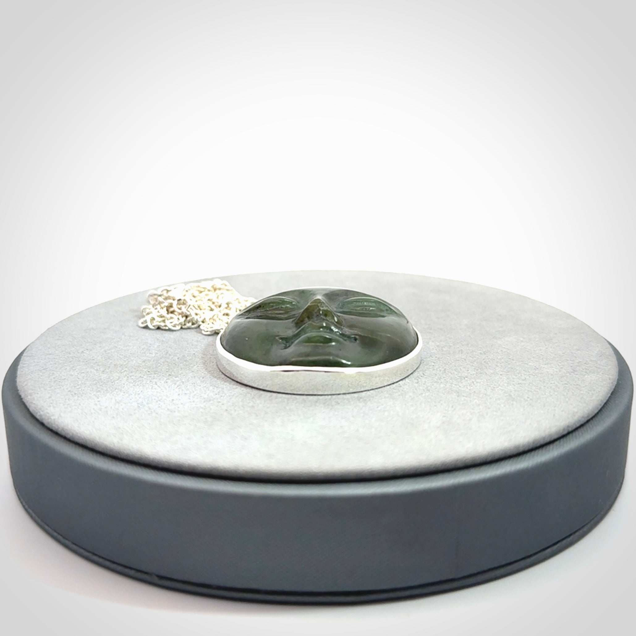Hand made New Zealand Jade moon face necklace with Sterling Silver. Made by NZ Pacific and sale online only. Delivered with sterling silver chain and packaged in a woven kete pouch.