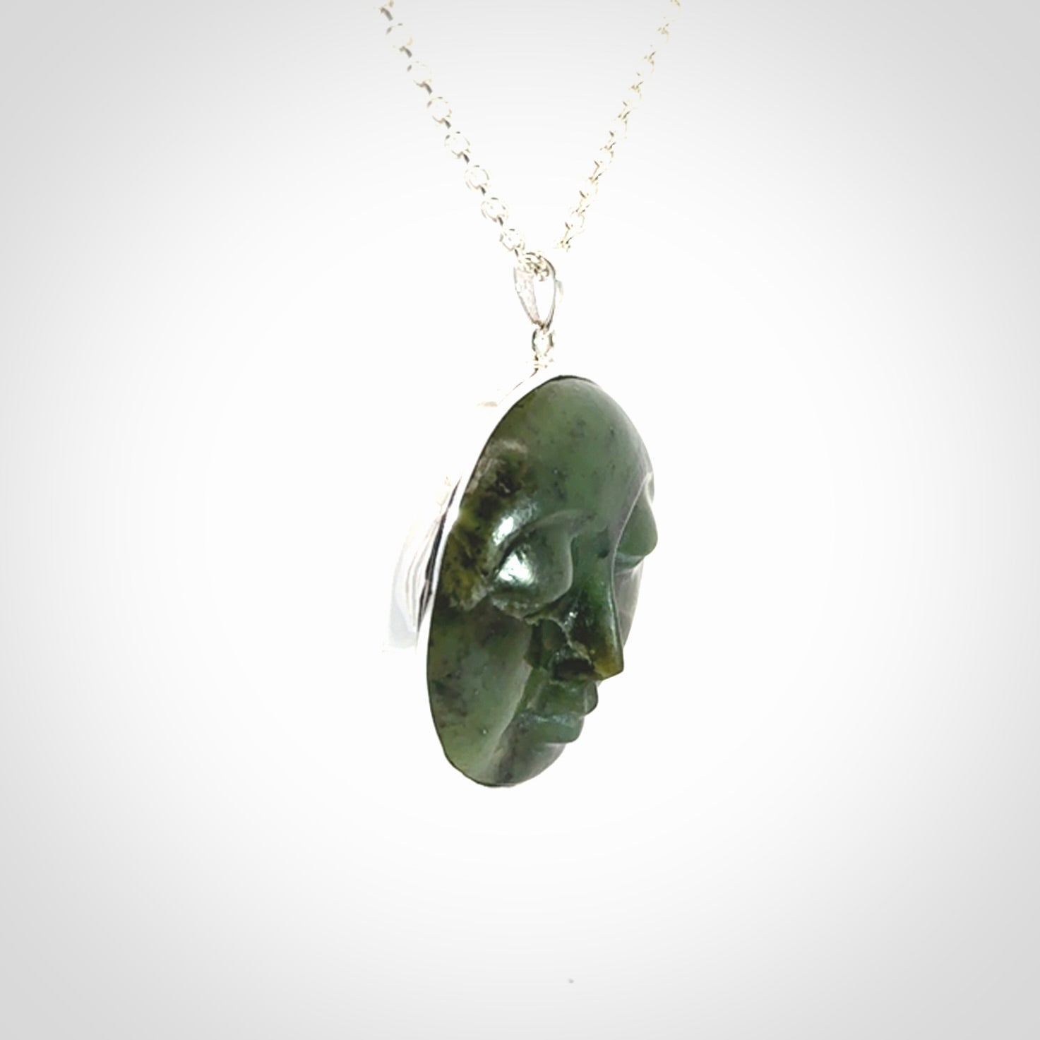 Hand made New Zealand Jade moon face necklace with Sterling Silver. Made by NZ Pacific and sale online only. Delivered with sterling silver chain and packaged in a woven kete pouch.
