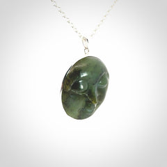 Hand made New Zealand Jade moon face necklace with Sterling Silver. Made by NZ Pacific and sale online only. Delivered with sterling silver chain and packaged in a woven kete pouch.