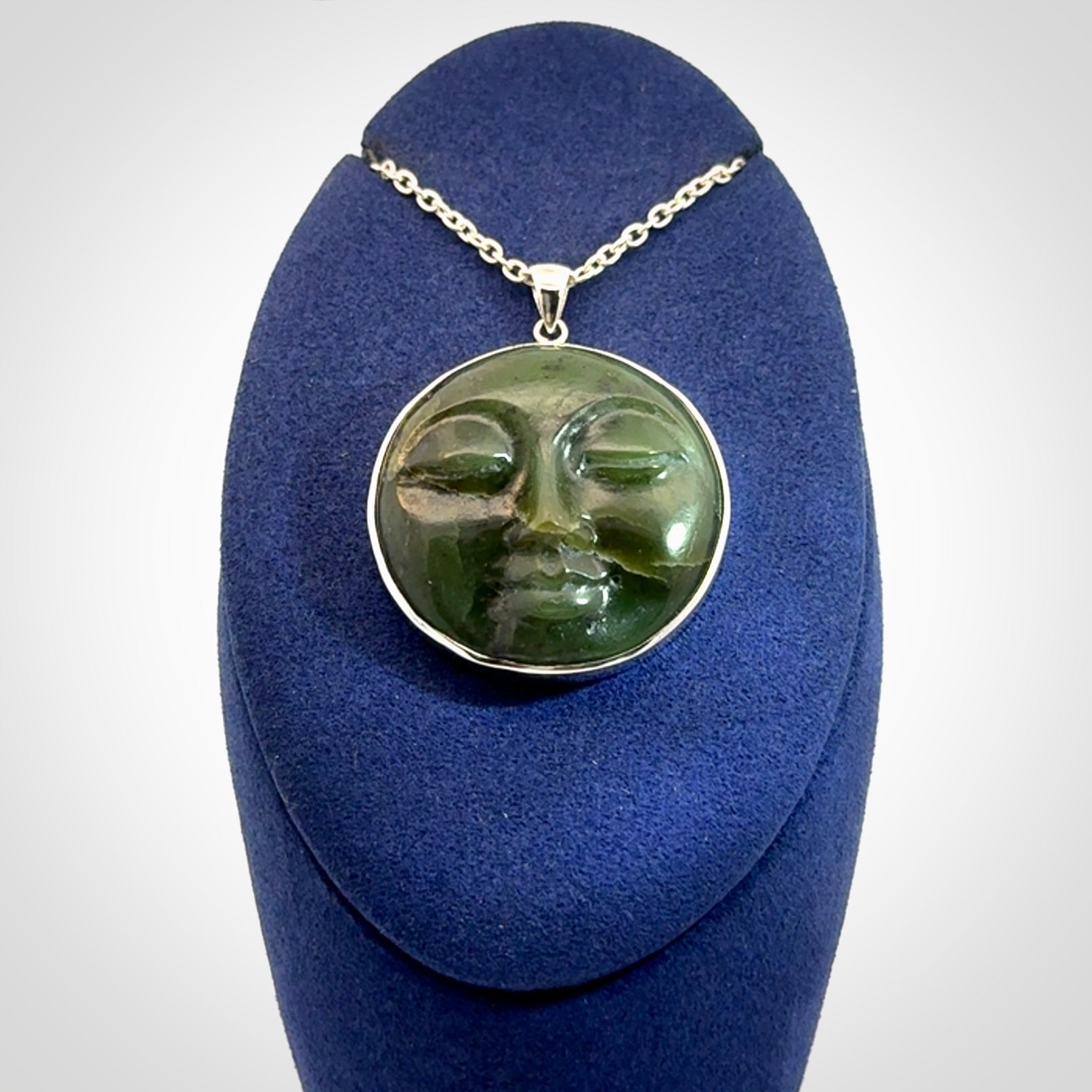 Hand made New Zealand Jade moon face necklace with Sterling Silver. Made by NZ Pacific and sale online only. Delivered with sterling silver chain and packaged in a woven kete pouch.