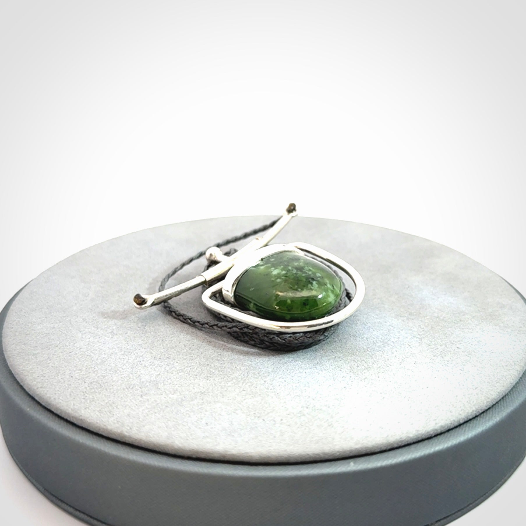 Hand crafted contemporary green jade and sterling silver drop necklace. This necklace is provided with a adjustable cord. Contemporary green jade drop necklace with sterling silver.