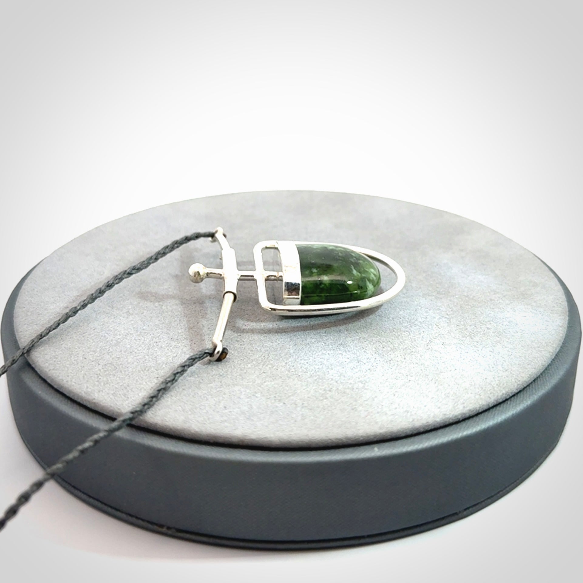 Hand crafted contemporary green jade and sterling silver drop necklace. This necklace is provided with a adjustable cord. Contemporary green jade drop necklace with sterling silver.