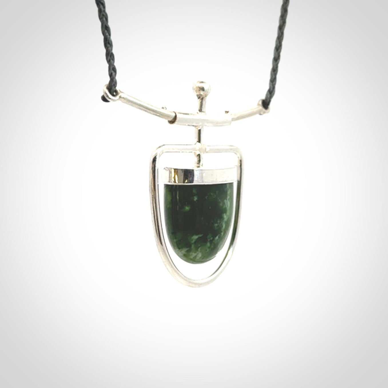 Hand crafted contemporary green jade and sterling silver drop necklace. This necklace is provided with a adjustable cord. Contemporary green jade drop necklace with sterling silver.