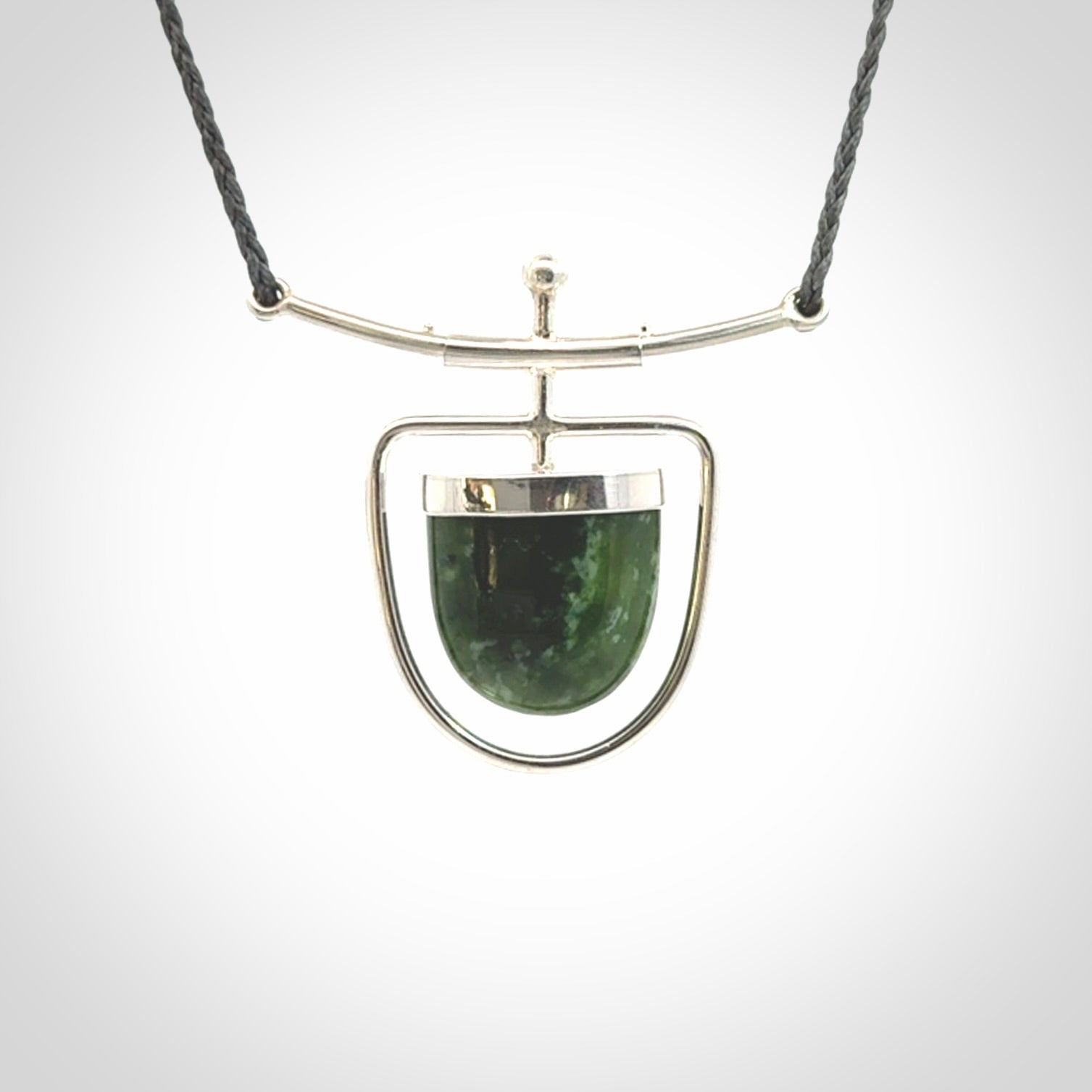 Hand crafted contemporary green jade and sterling silver drop necklace. This necklace is provided with a adjustable cord. Contemporary green jade drop necklace with sterling silver.