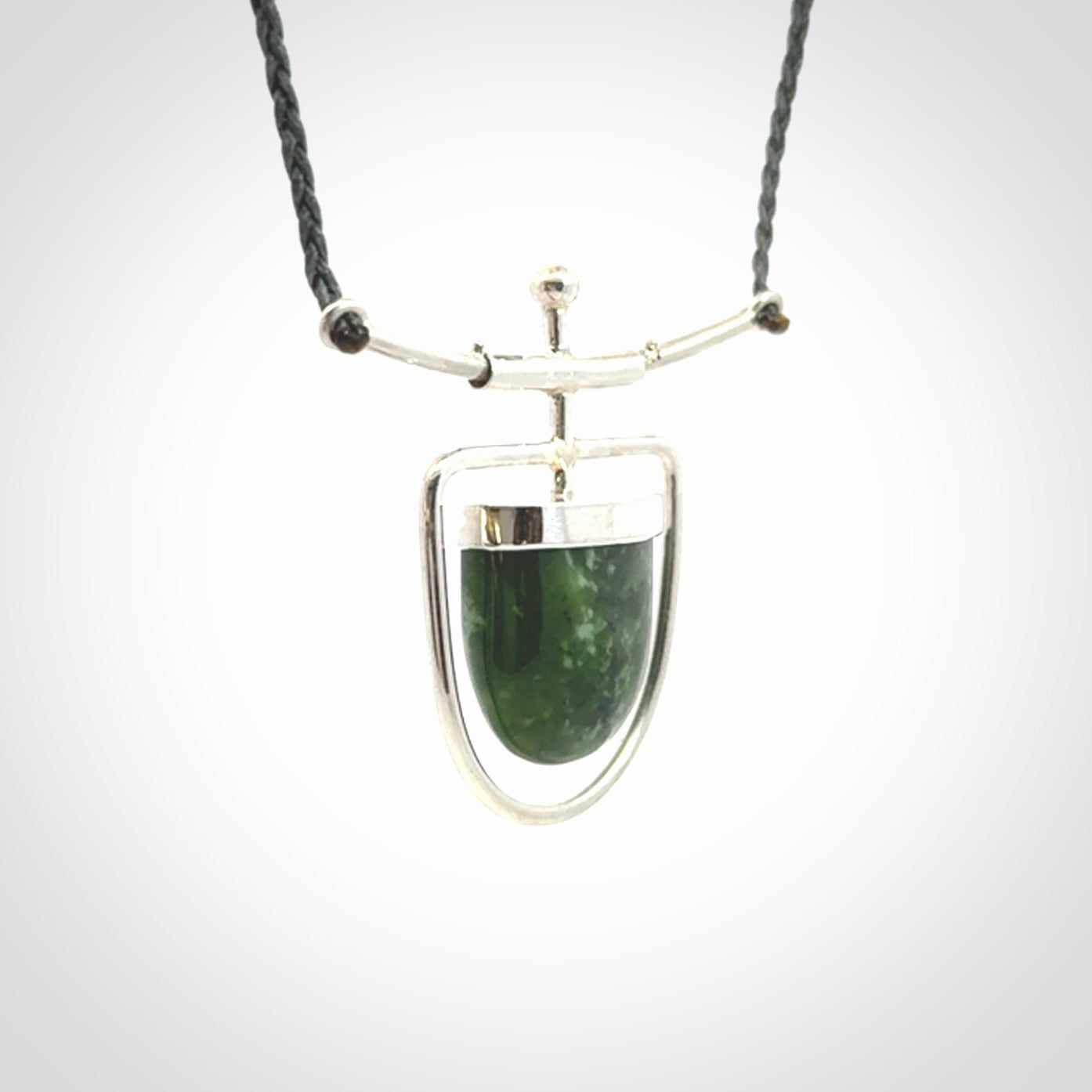 Hand crafted contemporary green jade and sterling silver drop necklace. This necklace is provided with a adjustable cord. Contemporary green jade drop necklace with sterling silver.