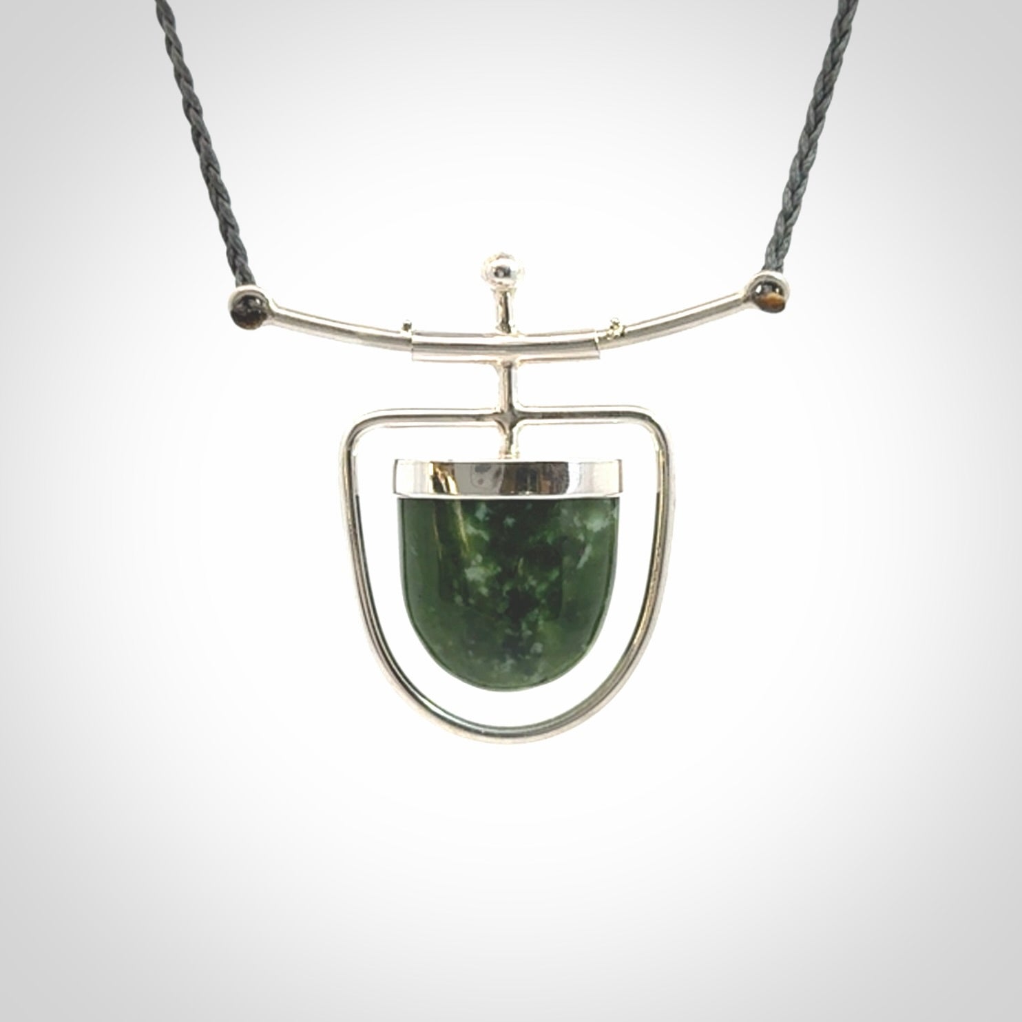 Hand crafted contemporary green jade and sterling silver drop necklace. This necklace is provided with a adjustable cord. Contemporary green jade drop necklace with sterling silver.