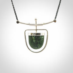 Hand crafted contemporary green jade and sterling silver drop necklace. This necklace is provided with a adjustable cord. Contemporary green jade drop necklace with sterling silver.