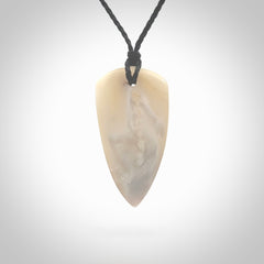 This photo shows a medium sized drop pendant hand carved from Mother of Pearl.This is a one only necklace for those who appreciate art to wear. It is provided with a cord in black that is a adjustable in length. We ship this piece worldwide and shipping is included in the price.