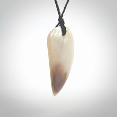 This photo shows a medium sized drop pendant hand carved from Mother of Pearl.This is a one only necklace for those who appreciate art to wear. It is provided with a cord in black that is a adjustable in length. We ship this piece worldwide and shipping is included in the price.