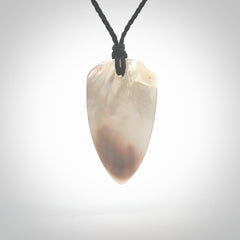 This photo shows a medium sized drop pendant hand carved from Mother of Pearl.This is a one only necklace for those who appreciate art to wear. It is provided with a cord in black that is a adjustable in length. We ship this piece worldwide and shipping is included in the price.