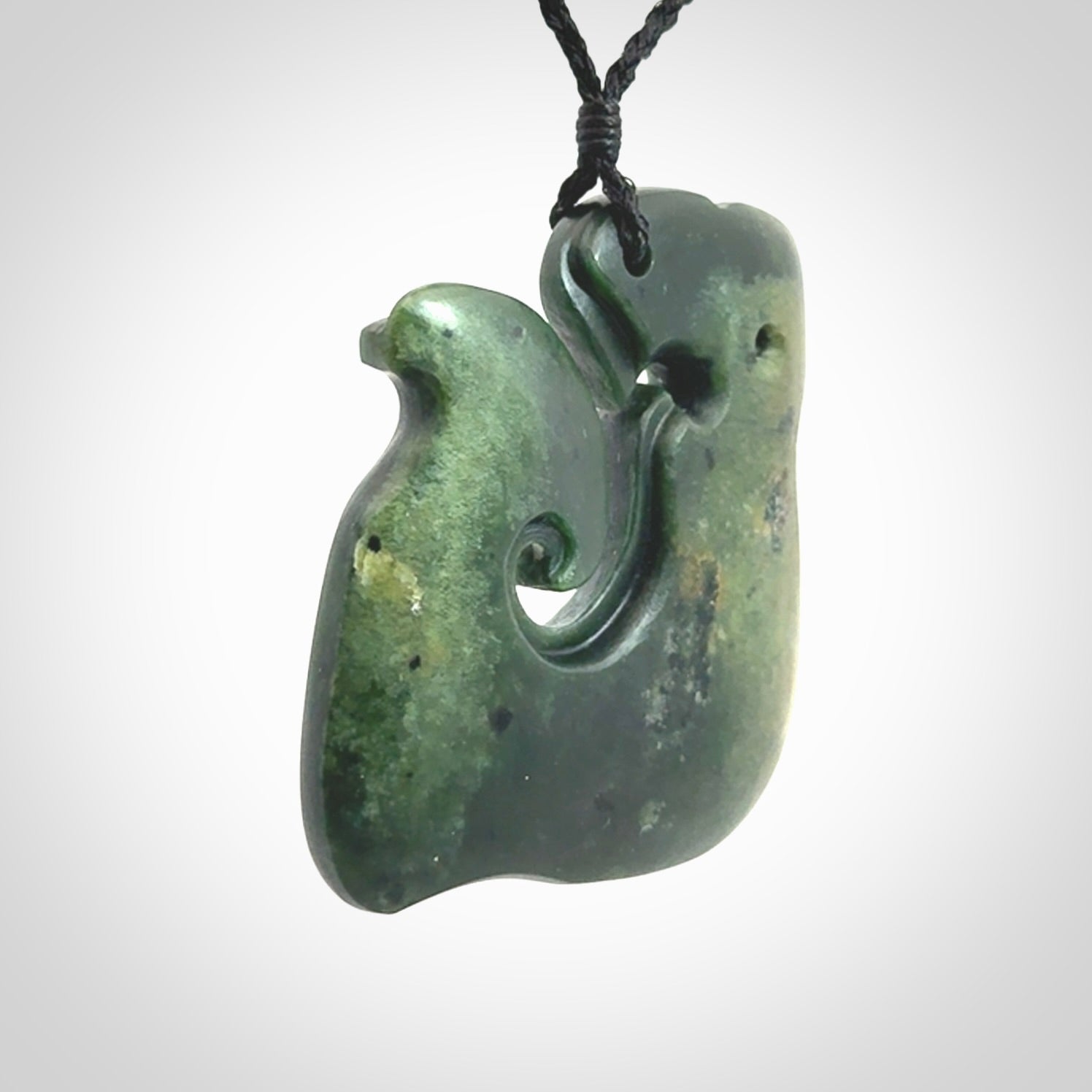 A beautiful hand carved, New Zealand Jade Matau, hook pendant.
