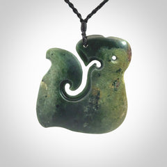 A beautiful hand carved, New Zealand Jade Matau, hook pendant.
