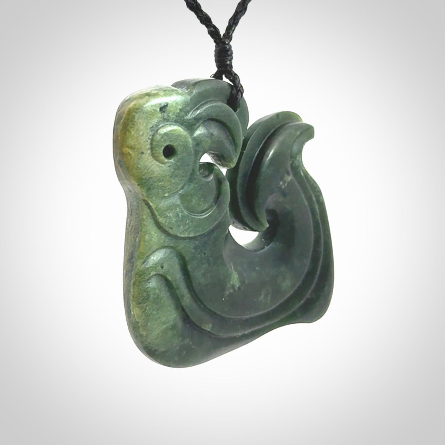 A beautiful hand carved, New Zealand Jade Matau, hook pendant.