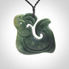A beautiful hand carved, New Zealand Jade Matau, hook pendant.