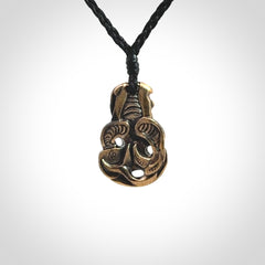 A beautiful hand made, bronze tiki pendant.