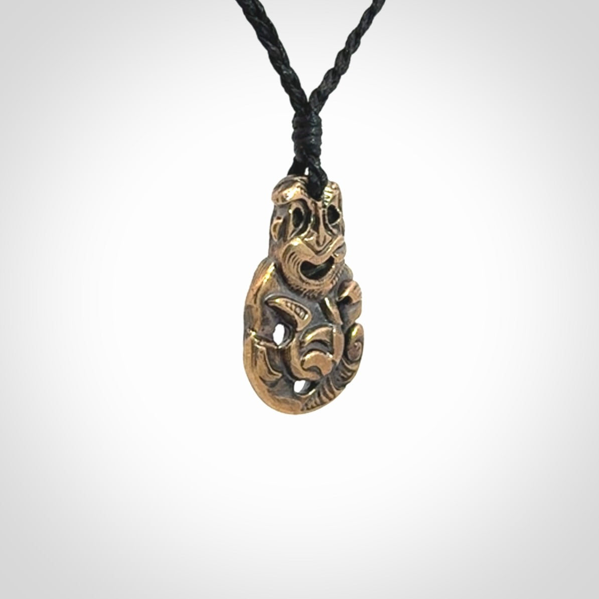 A beautiful hand made, bronze tiki pendant.