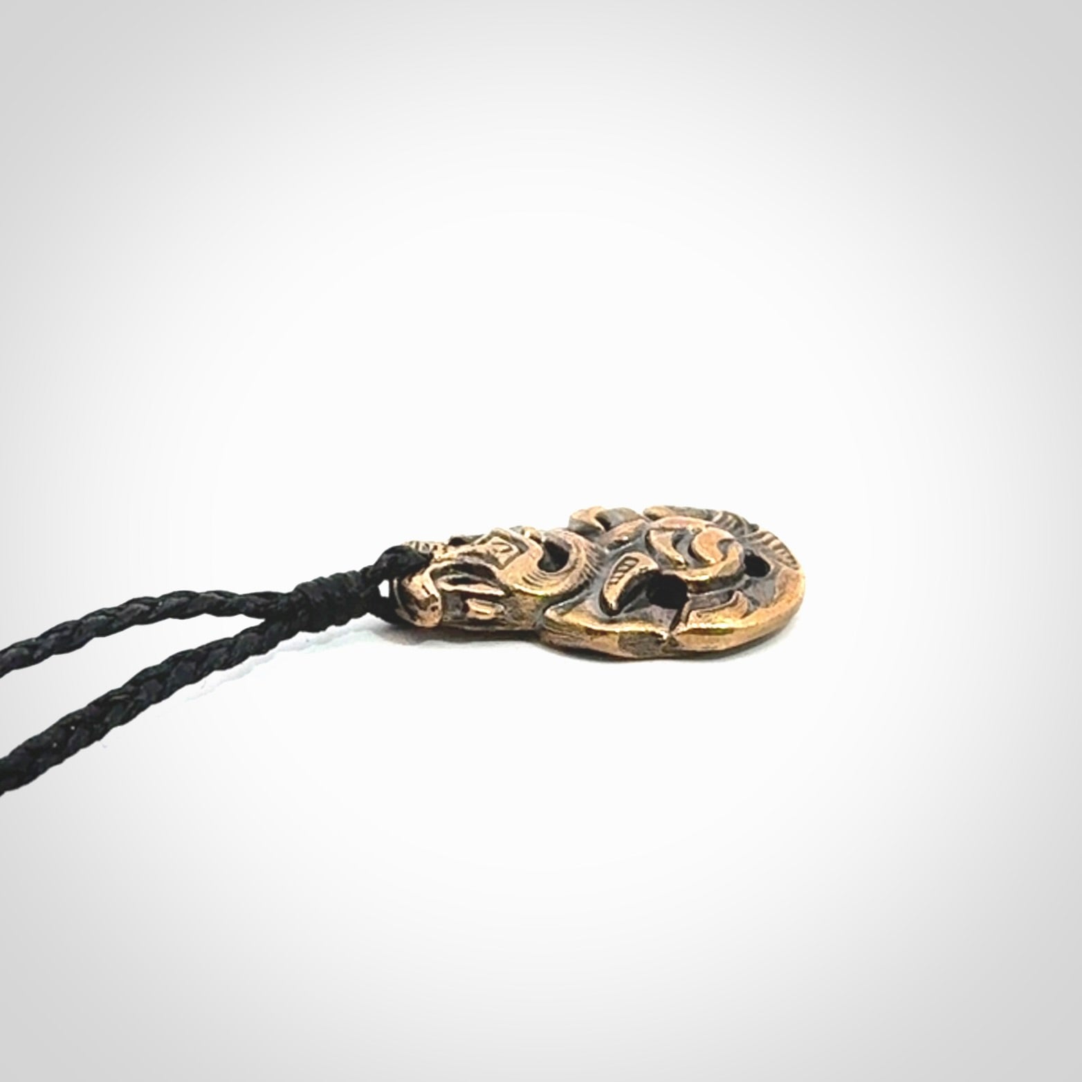 A beautiful hand made, bronze tiki pendant.