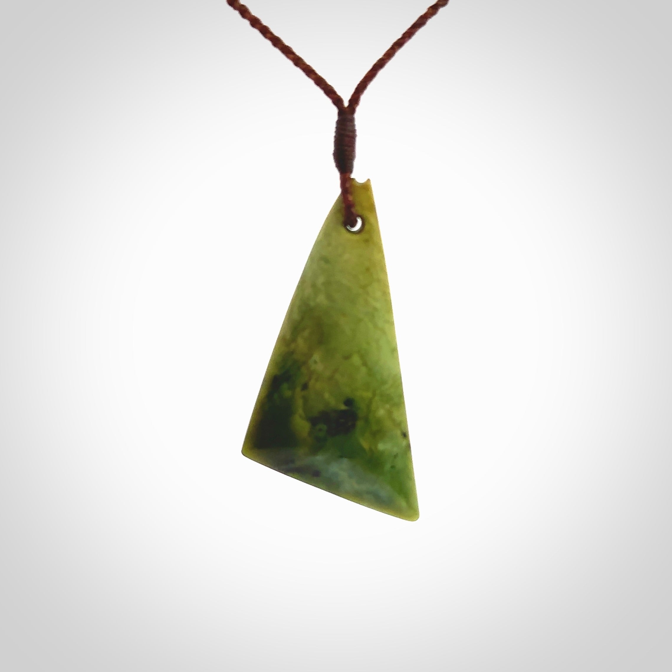 This is a lovely New Zealand Flower Jade, pounamu drop pendant. Hand carved for us by Kyohei Noguchi. It is bound with an adjustable brown coloured cord which is length adjustable. Free worldwide shipping.