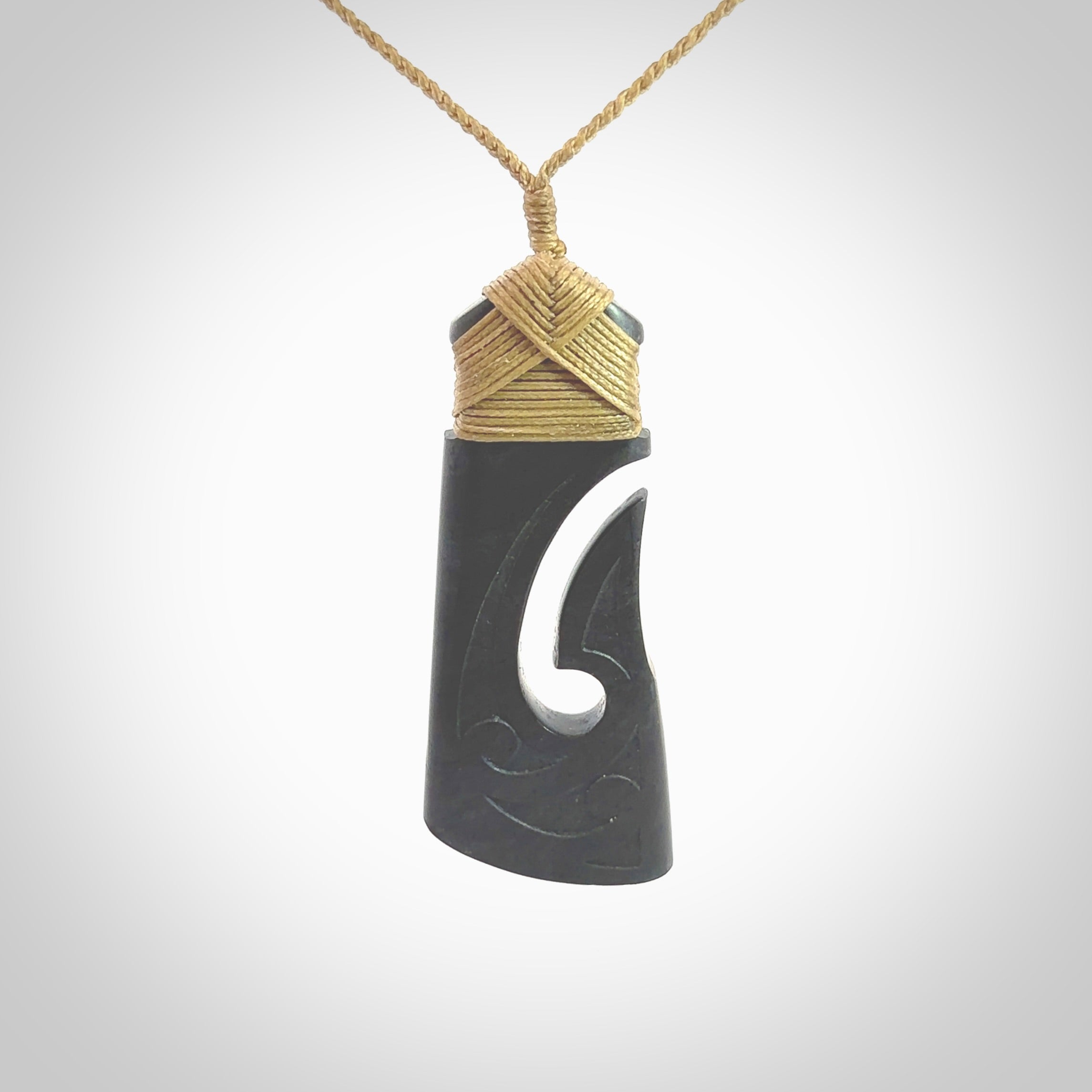 Hand made large New Zealand Argillite toki with hook pendant. Hand carved in New Zealand by Rueben Tipene. Hand made jewellery. Unique large Argillite Stone Toki and hook pendant with adjustable cord. Free shipping worldwide.