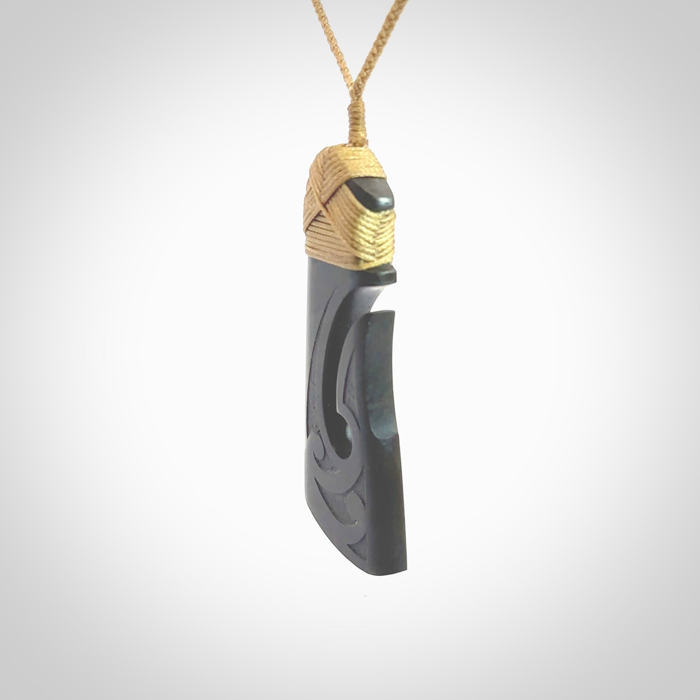 Hand made large New Zealand Argillite toki with hook pendant. Hand carved in New Zealand by Rueben Tipene. Hand made jewellery. Unique large Argillite Stone Toki and hook pendant with adjustable cord. Free shipping worldwide.
