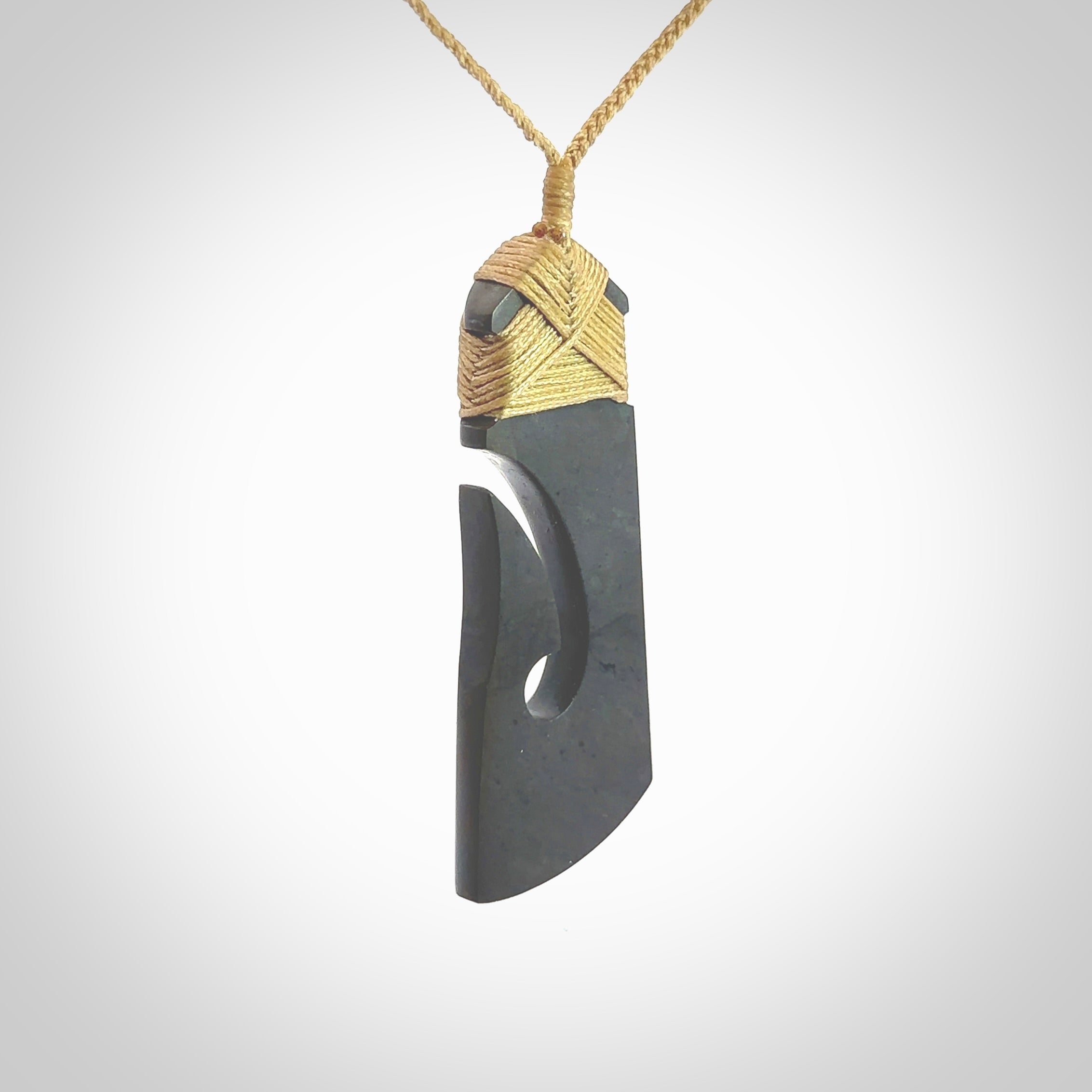 Hand made large New Zealand Argillite toki with hook pendant. Hand carved in New Zealand by Rueben Tipene. Hand made jewellery. Unique large Argillite Stone Toki and hook pendant with adjustable cord. Free shipping worldwide.