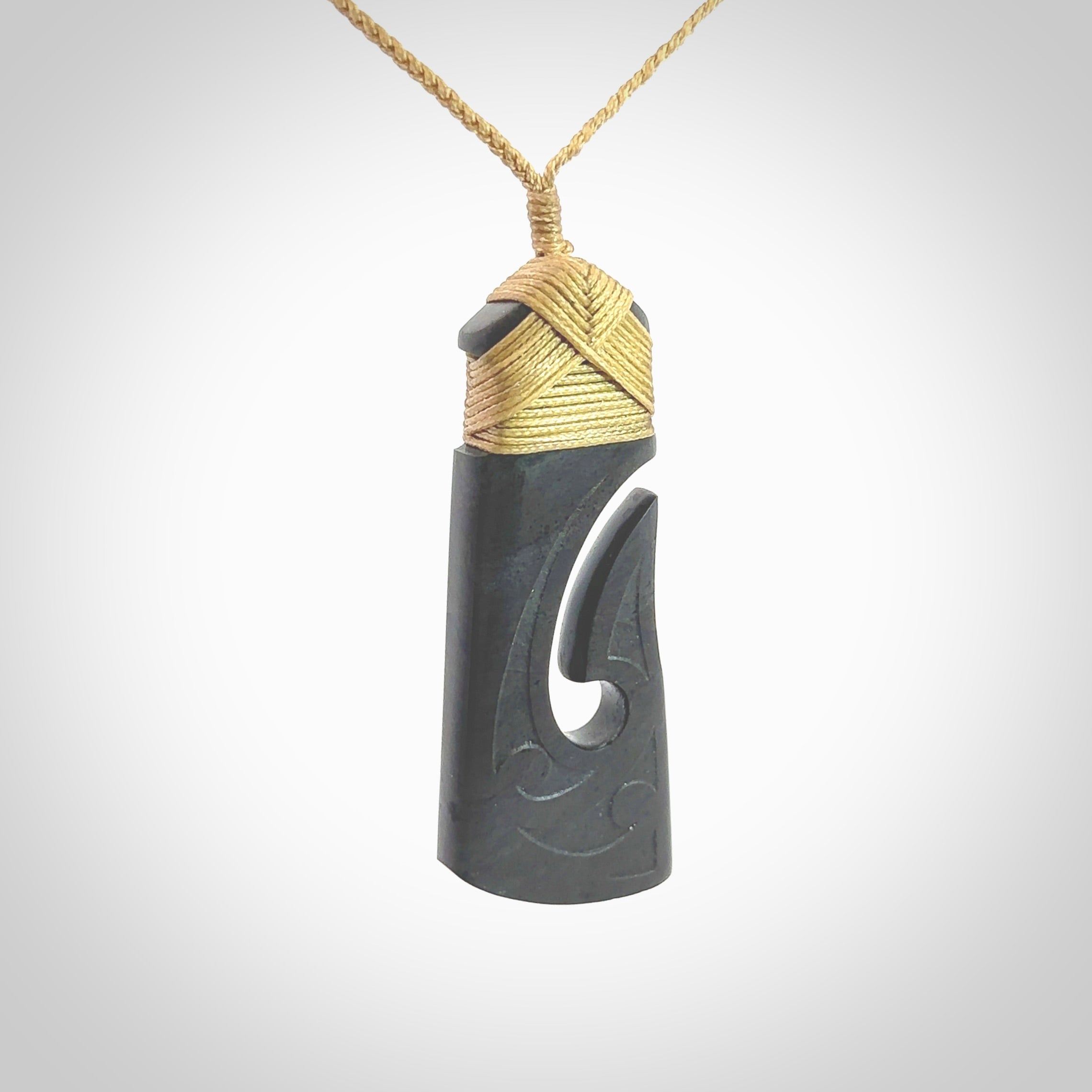 Hand made large New Zealand Argillite toki with hook pendant. Hand carved in New Zealand by Rueben Tipene. Hand made jewellery. Unique large Argillite Stone Toki and hook pendant with adjustable cord. Free shipping worldwide.