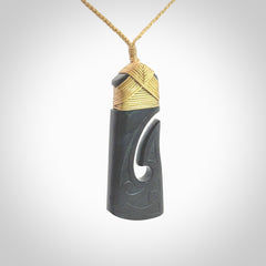 Hand made large New Zealand Argillite toki with hook pendant. Hand carved in New Zealand by Rueben Tipene. Hand made jewellery. Unique large Argillite Stone Toki and hook pendant with adjustable cord. Free shipping worldwide.