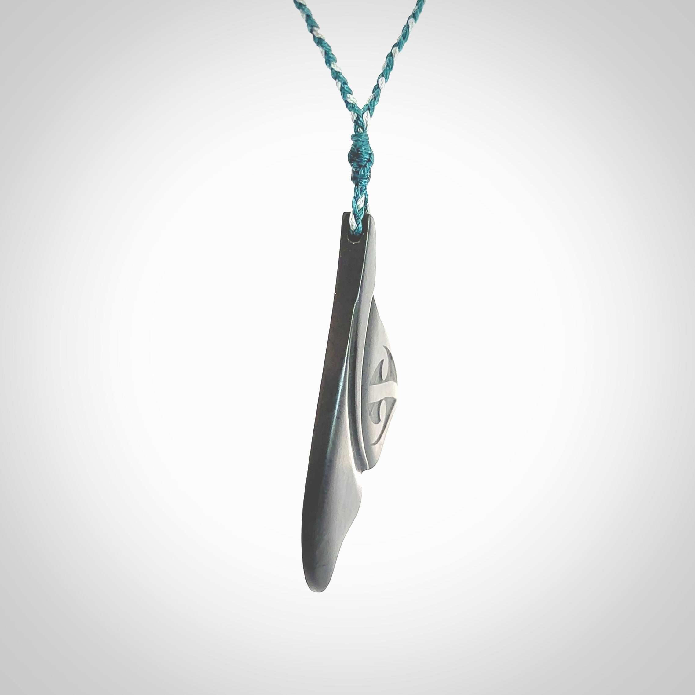 Hand carved New Zealand Argillite Stone whale tail pendant by Rueben Tipene. Hand made art to wear for lovers of the ocean. Delivered with express courier and delivered to you on an adjustable cord.