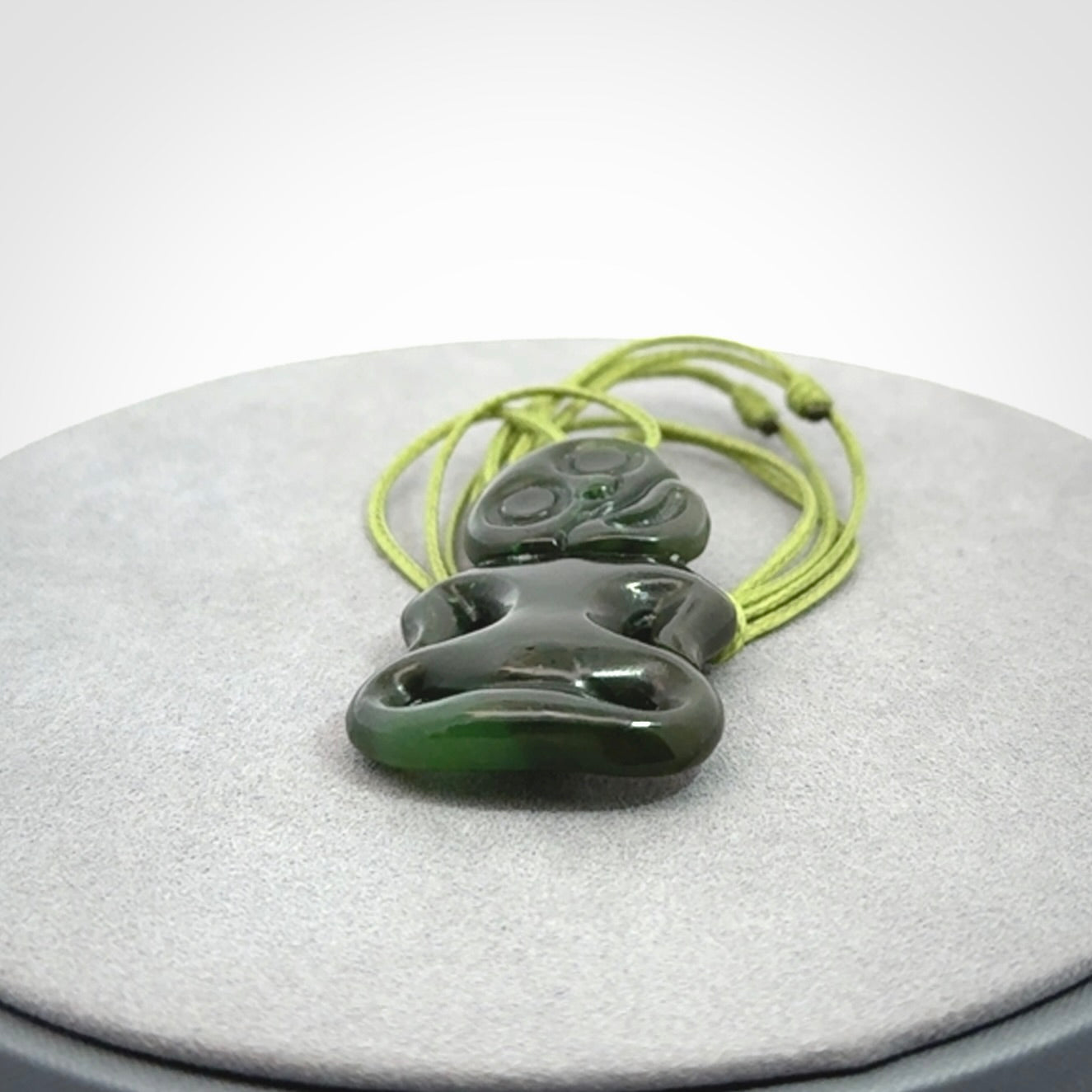 This pendant is a small jade tiki pendant. The carving shows wonderful detail on the front while the back is beautifully rounded. These are carved in Columbian Jade. The cord is adjustable in length. Provided in a woven kete pouch and shipped worldwide.