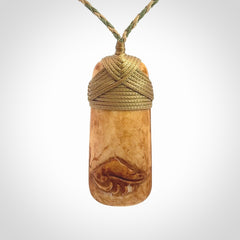 A hand carved bone toki pendant with NZ Pacific logo engraving. These have been stained with our home made tea dye. Unique hand made jewellery from New Zealand Pacific.
