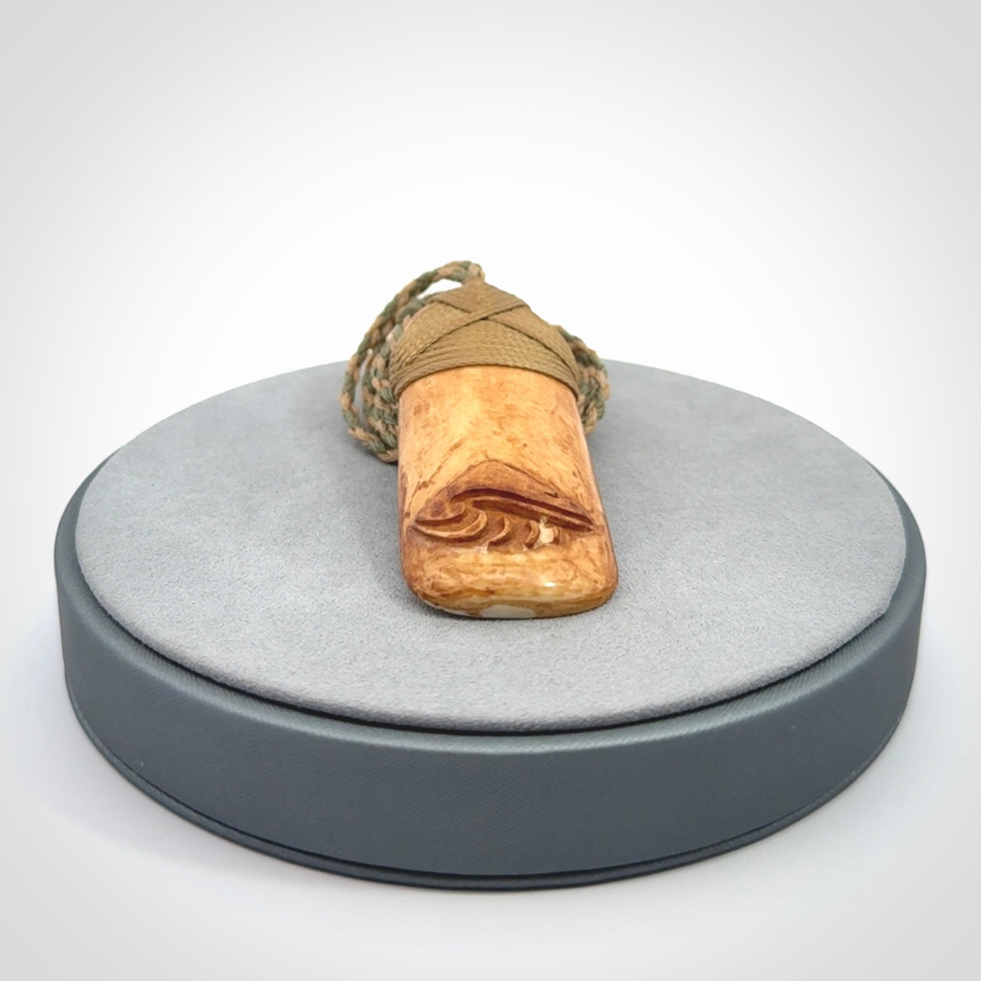A hand carved bone toki pendant with NZ Pacific logo engraving. These have been stained with our home made tea dye. Unique hand made jewellery from New Zealand Pacific.