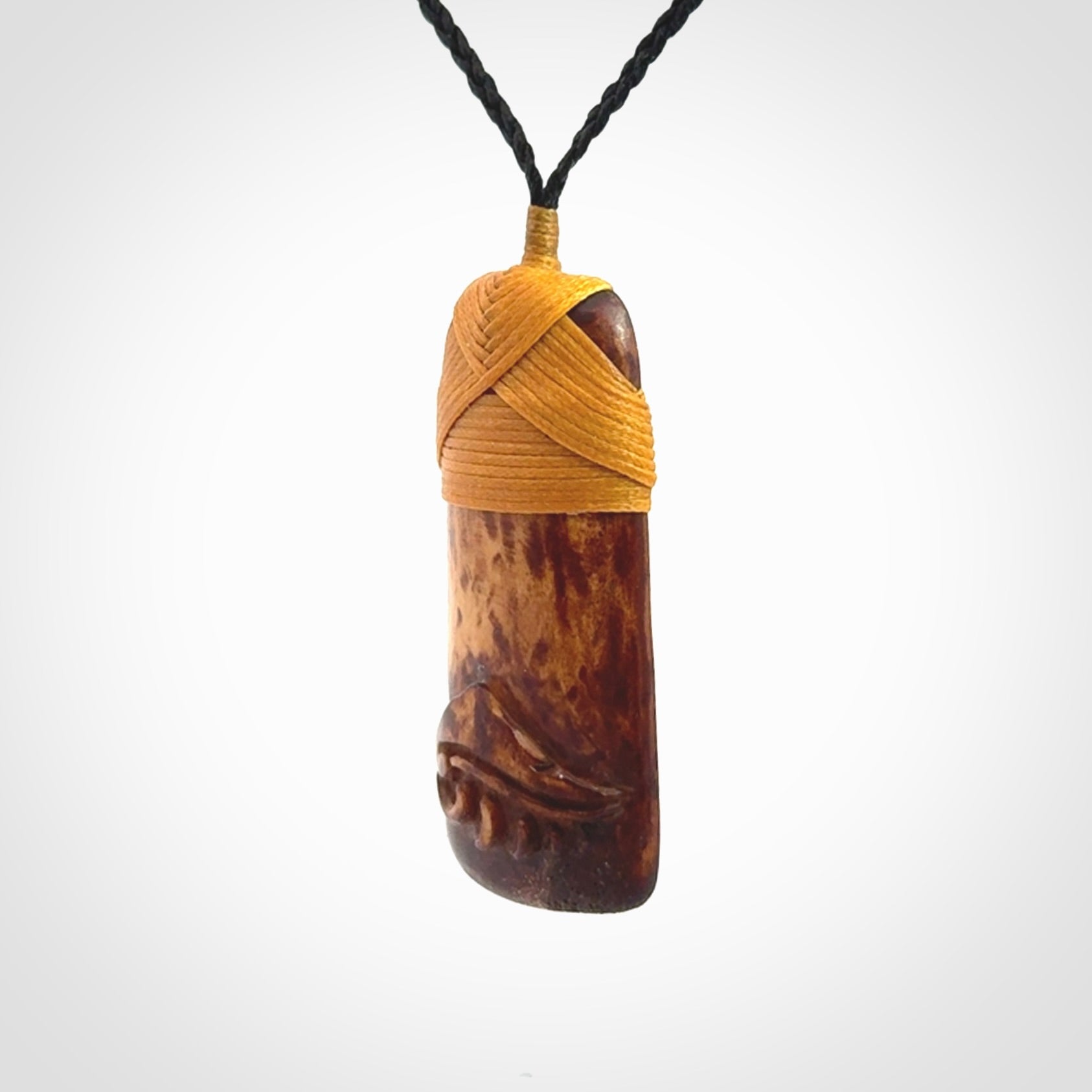 A hand carved bone toki pendant with NZ Pacific logo engraving. These have been stained with our home made tea dye. Unique hand made jewellery from New Zealand Pacific.