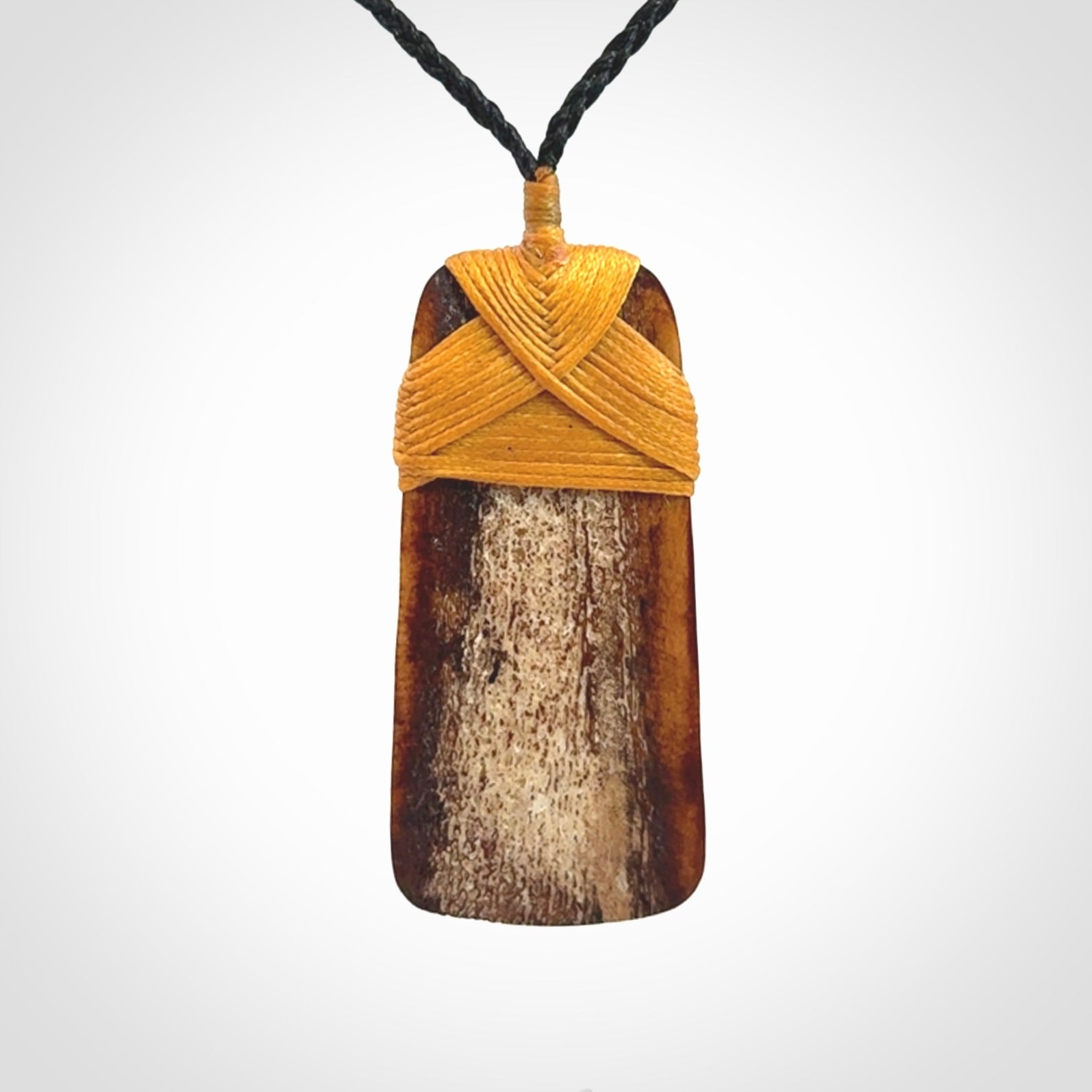 A hand carved bone toki pendant with NZ Pacific logo engraving. These have been stained with our home made tea dye. Unique hand made jewellery from New Zealand Pacific.