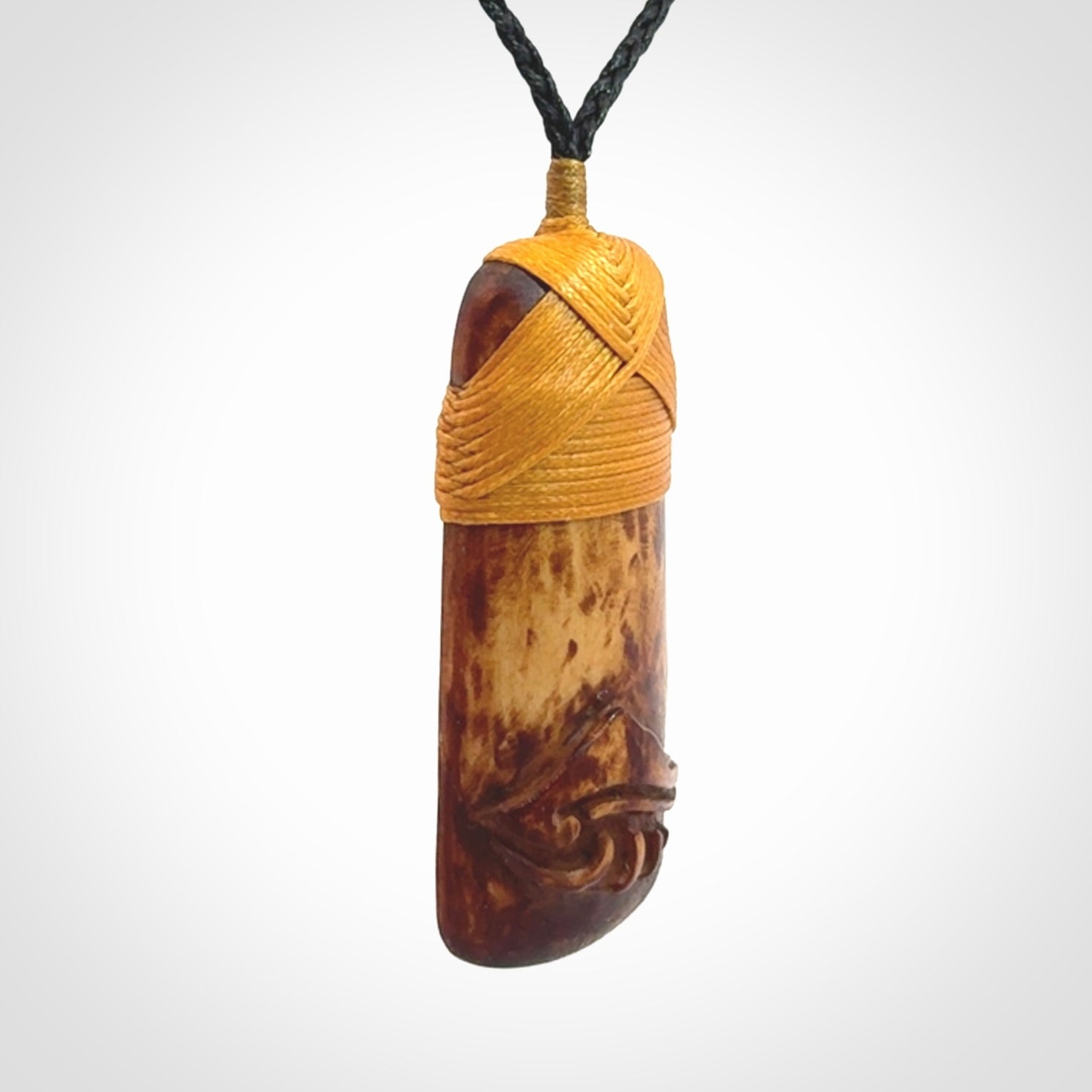 A hand carved bone toki pendant with NZ Pacific logo engraving. These have been stained with our home made tea dye. Unique hand made jewellery from New Zealand Pacific.