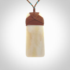 A hand carved bone toki with NZ Pacific logo engraving. Unique hand made jewellery from New Zealand Pacific.