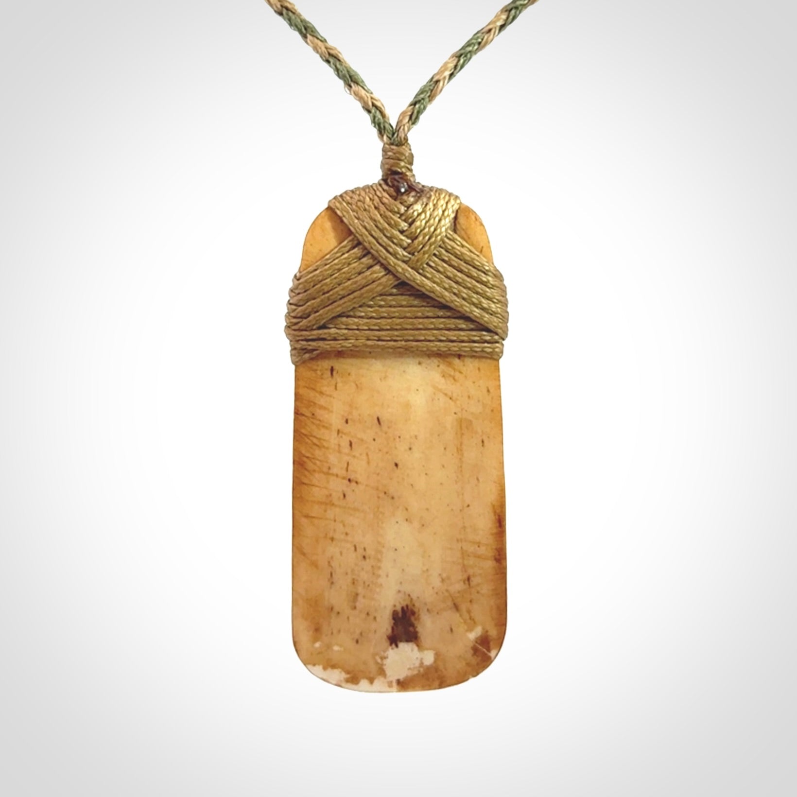 A hand carved bone toki pendant with NZ Pacific logo engraving. These have been stained with our home made tea dye. Unique hand made jewellery from New Zealand Pacific.