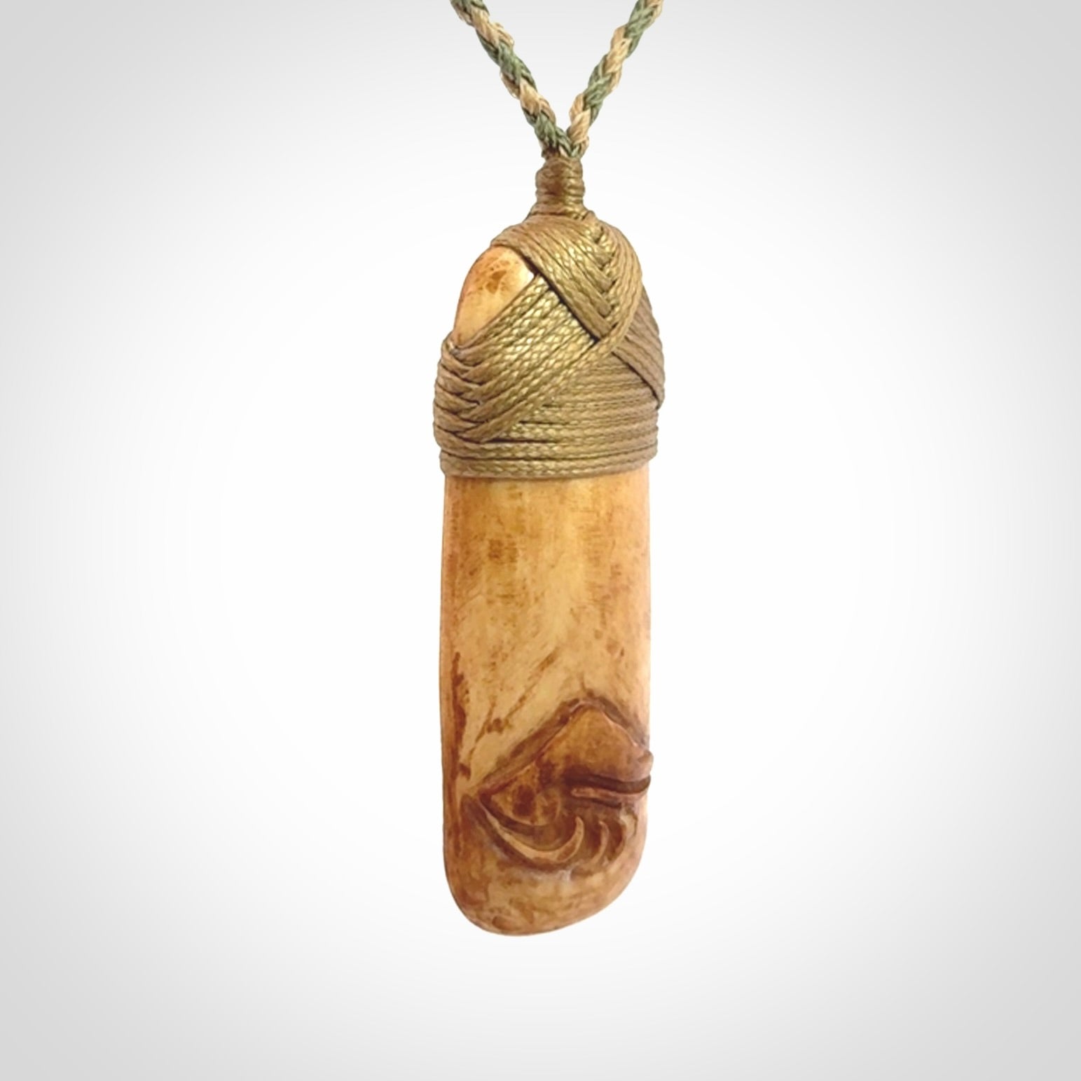 A hand carved bone toki pendant with NZ Pacific logo engraving. These have been stained with our home made tea dye. Unique hand made jewellery from New Zealand Pacific.